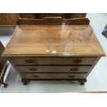 20th cent. Mahogany three drawer chest on cab supports. By Waring & Gillows.