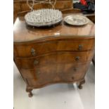 20th cent. Walnut serpentine chest of four drawers. 29ins.