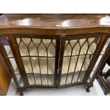 20th cent. Mahogany serpentine fronted display cabinet, ball & claw feet. 48ins. x 51ins. x 13½ins.