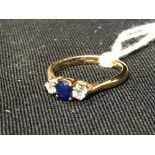 Hallmarked Gold: Three stone ring, central sapphire with diamonds either side, set in 18ct 750