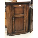 18th cent. Oak wall mounted corner cupboard with single door with shaped shelves. 30ins. x 40ins.