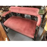 Edwardian mahogany framed 2 seater salon sofa, open back with fretwork splats. Overstuffed pink