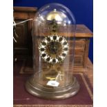 Clock: 20th cent. Brass skeleton clock chiming on the hour, treen base and circular glass dome.