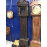 Clock: 18th cent. Oak brass faced unsigned longcase with later elaborately carved case. (Dial