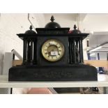 Clocks: Continental black slate mantle clock with domes and figures.