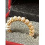 The Thomas E Skidmore Collection: Chinese gold jewellery. 18k yellow gold (tested) pearl full