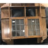 Early 20th cent. Oak wall hung display cabinet with 9 shelves and 2 leaded glass doors.