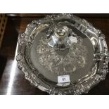 Plated Ware: An ornate carved and embossed serving tray 12½ins diameter, plus a plated ware Mappin &