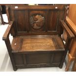 20th cent. Oak monks bench with carved circular panel depicting a mountain scene to the back.