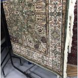@21st cent. Carpet: Keshan, green ground with blues, reds, and ivory. Three borders. 2.3m. x 1.6m.