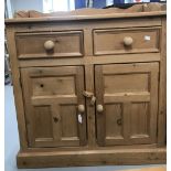 20th cent. Pine cupboard, 2 drawers over twin doors, solid gallery back. 35½ins. x 33ins. x 17½ins.