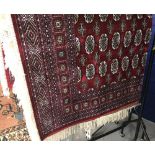 @21st cent. Rug: Bokhara, red ground with stylised geometric designs in reds, blues, ivory and