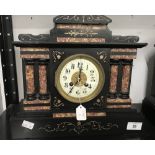 Clocks: 19th cent. Black slate and pink marble mantel clock with brass and enamel face and coil