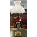 Lighting: 19th/20th cent. Oil lamp with Corinthian style stand supporting cranberry glass