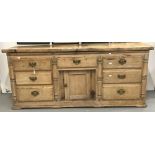 19th cent. Continental pine, seven drawer, one cupboard, dresser base with later top.