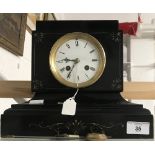 Clocks: 19th cent. Black slate mantel clock with French movement, enamel face and bell chime.