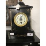 Clocks: Black slate and marble mantel clock with dome and finial, decorated enamel face and coil