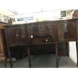 20th cent. Mahogany sideboard, serpentine fronted, two door and two drawers, with brass lions head