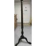 20th cent. Mahogany standard lamp reeded column, tripod supports resting on ball and claw feet.