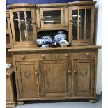 Early 20th cent. Rustic pine dresser, 3 door with bowed glass cupboards to the rack section. 58½