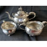 Colonial Silver: Indian three piece tea set with stylised decoration and elephant finial to tea pot,