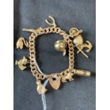 Jewellery: 9ct gold heavy link (hollow) rose gold with eleven 9ct charms. 29.8gms.
