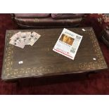 20th cent. Asian hardwood coffee table with brass inlay and glass top. 42ins. x 22ins. x 18ins.