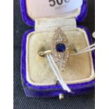 Jewellery: Marquise shaped diamond and sapphire set ring with centrally set sapphire surrounded by