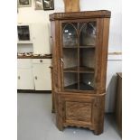 20th cent. Walnut corner cupboard, two doors, top door glazed with Gothic arch mouldings, lower door