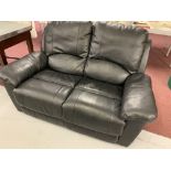 21st. cent. Leather two seater reclining black settee.