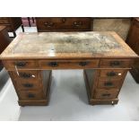 20th cent. Oak twin pedestal nine drawer desk topped with leather scriber. 47½ins. 29ins. x 23ins.