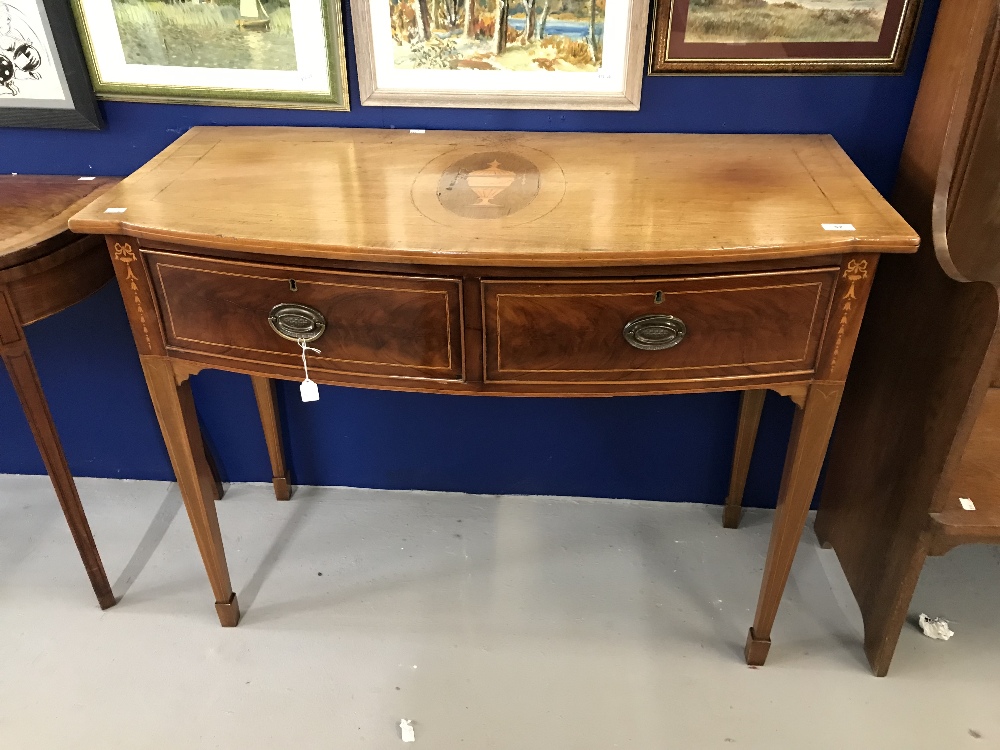19th cent. Mahogany bow fronted hall table. The top decorated with an oval panel depicting an inlaid