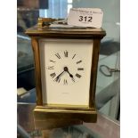 Clocks: Brass carriage clock. White enamel face, Roman numerals, signed Garrard. Movement signed W.