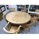 20th cent. Circular pine table with single pedestal, 54ins. diameter, and six beech chairs including