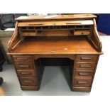 Oak double pedestal tambour desk with fitted interior.