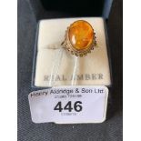 Jewellery: 9ct. Gold ring with oval inset amber setting with inclusions.