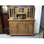 Early 20th cent. Rustic pine dresser, 3 door with bowed glass cupboards to the rack section. 58½