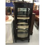 Edwardian mahogany serpentine fronted glass display cabinet on cabriole supports.