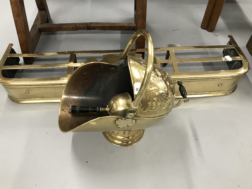 Late 19th/early 20th cent. Brass and iron fender plus helmet style coal scuttle and shovel.