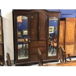 20th cent. Mahogany compactum, twin doors over hanging compartments with top shelves. The base on