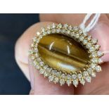 The Lady Lowry Jewellery Collection: Diamond jewellery. Oval tigers eye surrounded by a double