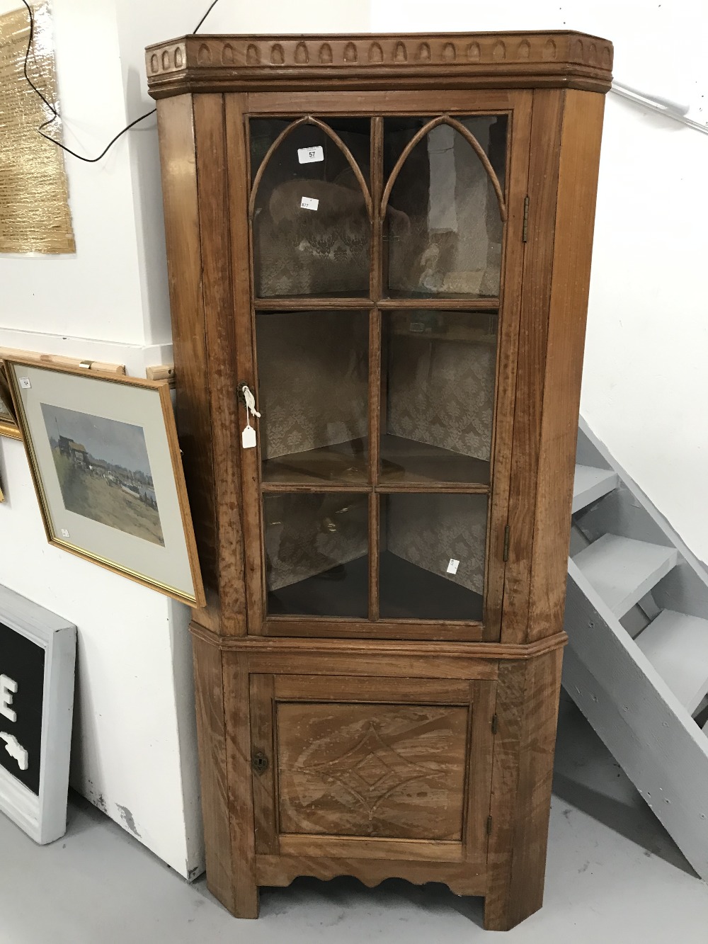 20th cent. Walnut corner cupboard, two doors, top door glazed with Gothic arch mouldings, lower door