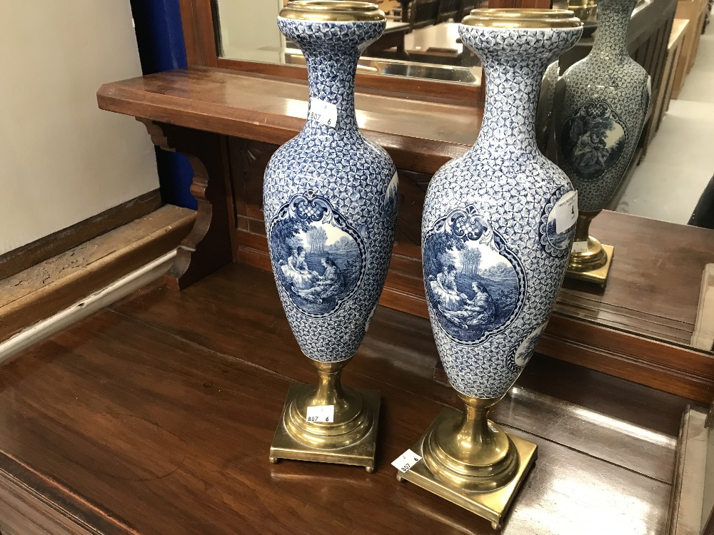 Ceramics: 20th cent. Continental vases with brass base stands and rims, decorated with panels