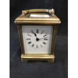 Clocks: 19th cent. Brass carriage clock, white enamel face with Roman numerals, unsigned movement.