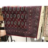 @21st cent. Rug: Bokhara, red ground with stylised geometric designs in reds, blues, ivory and