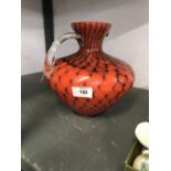 20th cent. Czech art glass pitcher. Orange with peacock feather stylised design. 9ins. Unsigned.