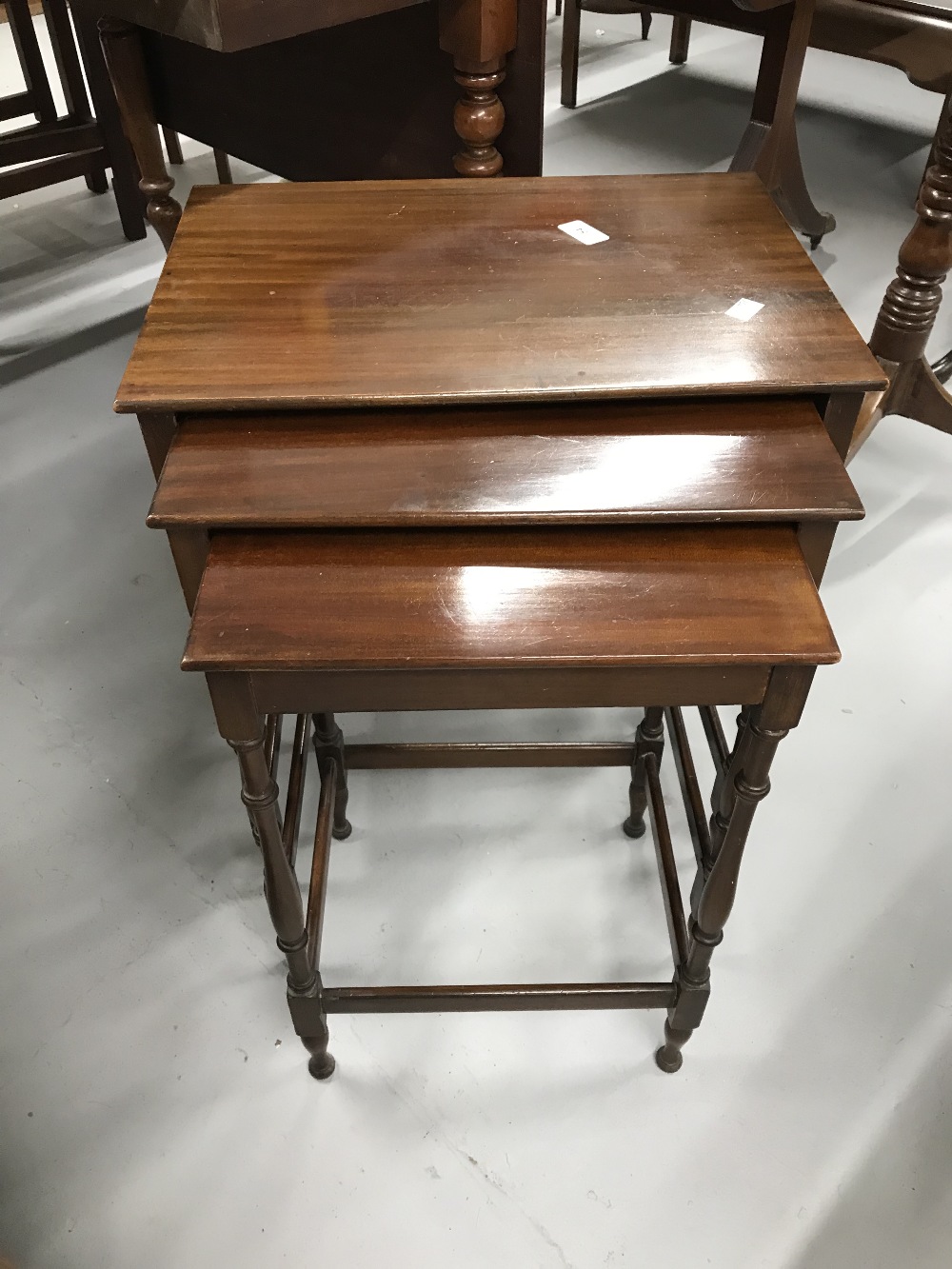 20th cent. Mahogany best of three tables of modest proportions.