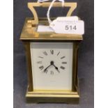 Clocks: Brass carriage clock. White enamel face, Roman numerals, signed Garrard. Movement signed W.