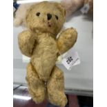 Toys: Mid 20th cent. Teddy bear, plush, with a stitched nose, glass eyes, red tongue, and