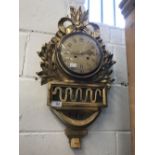 Clocks: 20th cent. Swedish wall clock by Westerstrand, giltwood with ribbon decoration. 25ins.